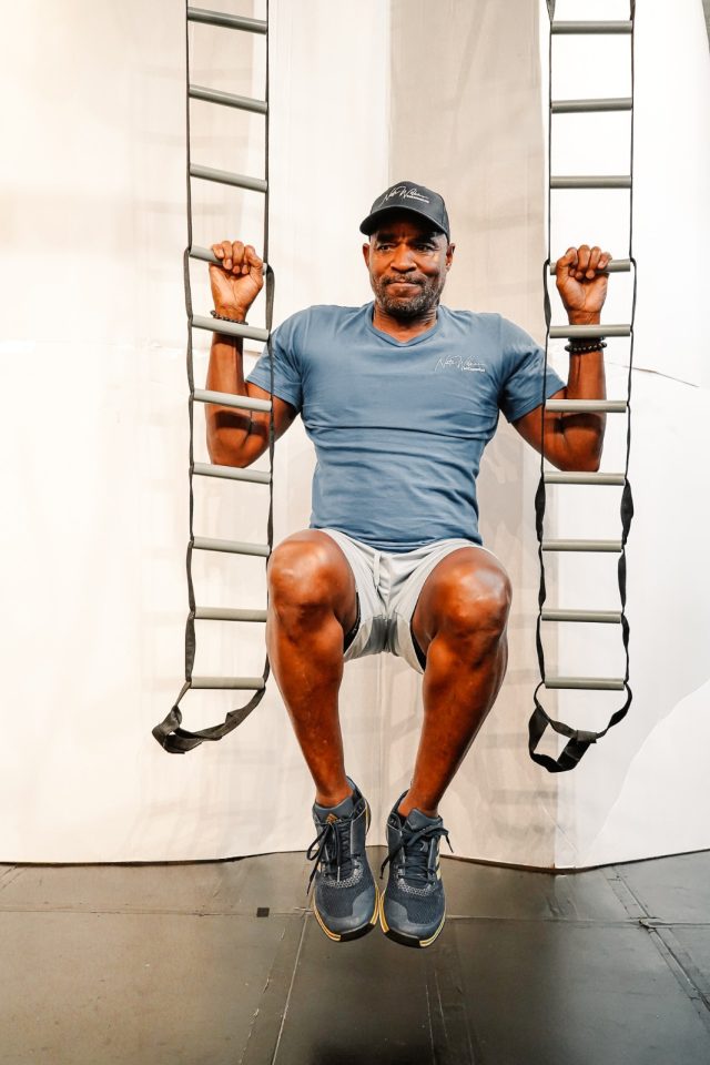 senior Black man climbing rope ladder exercise